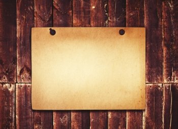 Old paper on grunge wood background 