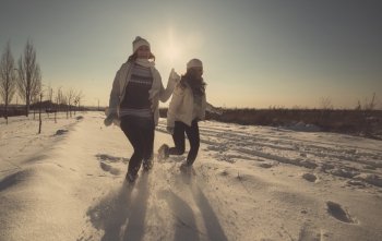 Two girlfriends have fun at beautiful winter day, tinted photo