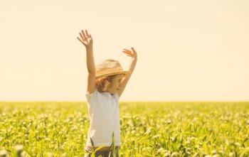 Little blonde girl in a wheat field, summer outdoor