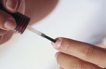 Close-up of a person´s hand applying nail polish