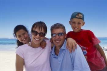 Portrait of a couple with their children on the beach