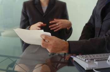 Midsection view of a businesswoman and a businessman in a meeting