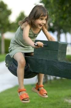 Laughing Caucasian Girl Riding A Seesaw