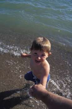 Excited Little Boy At The Ocean