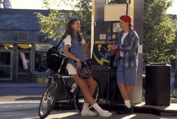 Teenage Boy And Girl Talking At Gas Pump