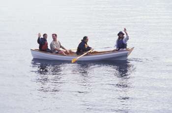 Group Of Friends Waving From A Canoe