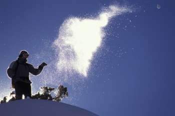 snowboarder throws snowball