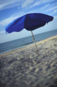 Blue Umbrella On A Warm Sandy Beach