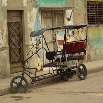 pedicab parked on the side of a street, Havana, Cuba