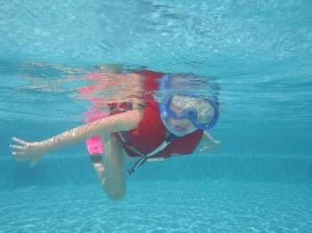 Underwater view of a young woman wearing scuba gear, Moorea, Tahiti, French Polynesia, South Pacific