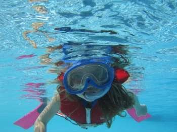 Underwater view of a young girl (12-13) scuba diving, Moorea, Tahiti, French Polynesia, South Pacific