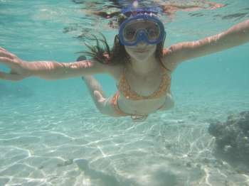 Underwater view of a young woman scuba diving, Moorea, Tahiti, French Polynesia, South Pacific