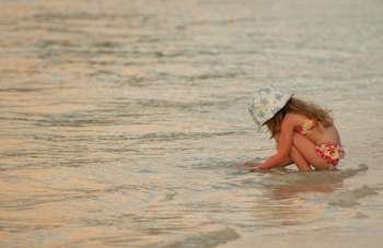 A young girl (6-8) playing in the sea, Moorea, Tahiti, French Polynesia, South Pacific
