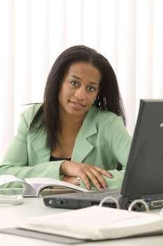 Woman At Desk Using Laptop