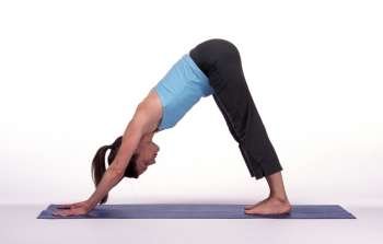 Woman in Downward Dog Pose on Mat