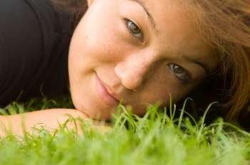 Young Woman Lying on Grass