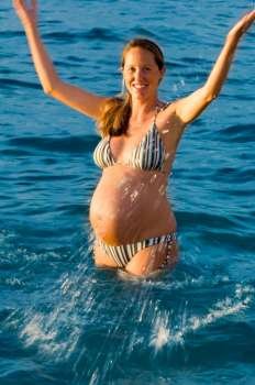 Pregnant Woman Splashing in Water