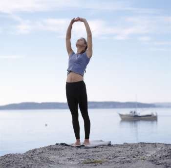 Young woman exercising on the beach