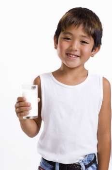 Close-up of a boy holding a glass of milk