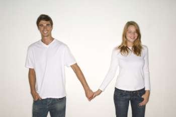Portrait of a young couple holding each other´s hands and smiling
