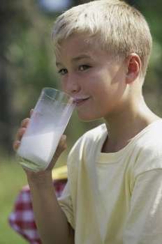 Side profile of a boy drinking milk from a glass