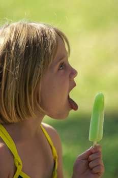 Side profile of a girl holding an ice cream