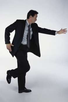 Side profile of a businessman dancing
