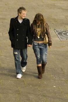 Teenage boy and a teenage girl walking on the road