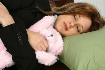 Businesswoman sleeping with a stuffed toy
