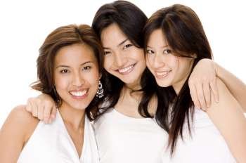 Portrait of three young women smiling