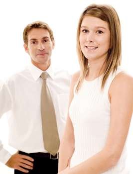 Businesswoman smiling with a businessman standing behind her