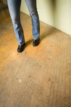 Legs standing on a wooden floor