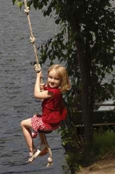 Closeup child swinging on rope