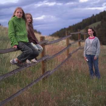 Girls by fence in Montana