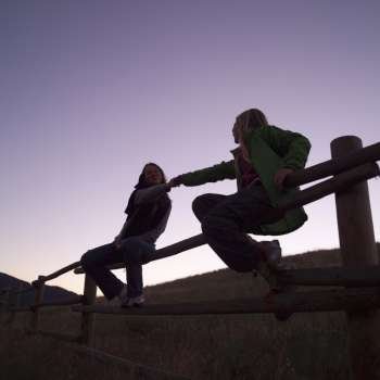 Silhouette of girls on fence