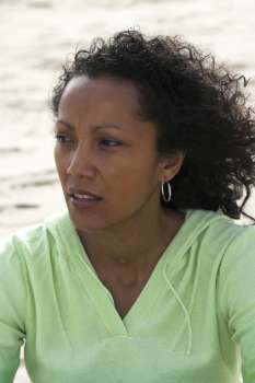 Beautiful black woman on the beach with a thoughtful look