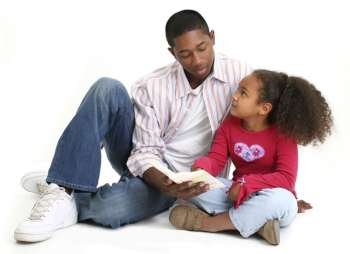 African American father and daughter reading child´s bible