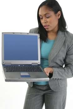 African American woman in business clothes working on laptop computer