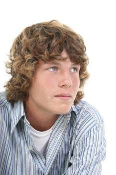 Attractive Sixteen Year Old Teen Boy in casual over white background. Light brown curly hair and hazel eyes. 