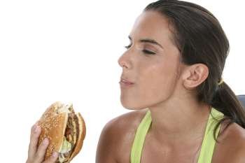 Beautiful Teen Girl Holding Colorful Weights and a Giant Cheeseburger. 