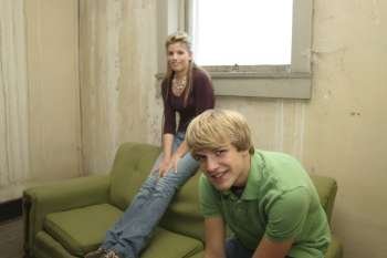 Teen boy and girl in old apartment.