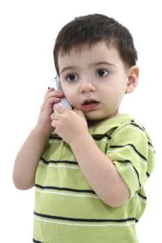 Adorable Toddler Boy Speaking On A Cordless Phone Over White. 