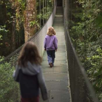 Girls going across suspension bridge in Costa Rica