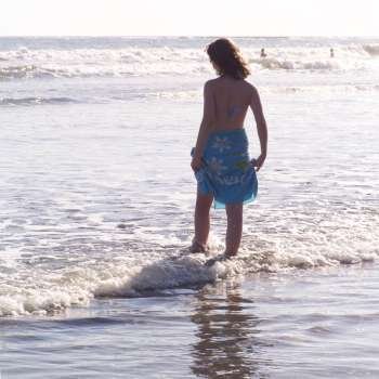 Teenage girl standing in the ocean