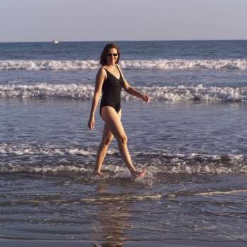 Woman walking in ocean