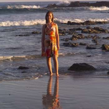 Teenage girl standing at shoreline