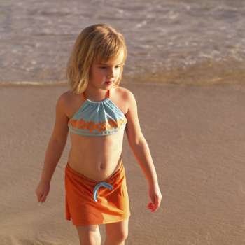 Five year old walking on the beach