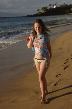 Girl walking down beach