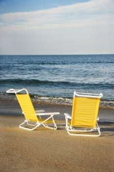 Empty lounge chairs on beach on Bald Head Island, North Carolina.