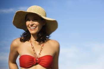 Caucasian mid-adult female in swimsuit and straw hat.